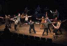 The 15 members of the cast, all Trent University students, during a dress rehearsal of the musical song cycle "The Theory of Relativity", which runs for six performances from March 13 to March 26, 2020 at Market Hall Performing Arts Centre in downtown Peterborough. Musical director Justin Hiscox and his band, made up of Sam Quinn, Nick Gilroy, and Mark Hiscox, are pictured in the background. (Photo: Alyssa Cymbalista)