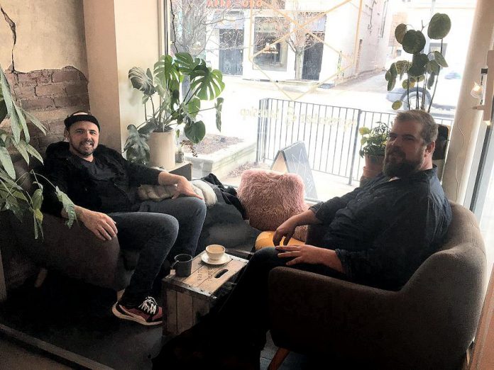"We're already going to hot yoga and my gym is right downtown." Hawksley Workman (left) chats with kawarthaNOW's music writer Josh Fewings about his move to Peterborough at Kit Coffee in downtown Peterborough on March 10, 2020. (Photo courtesy of Kat Kennedy / Kit Coffee)