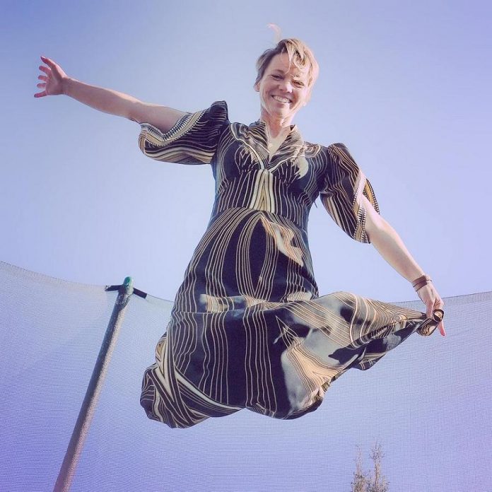 Port Hope artist Lee Higginson celebrating her birthday on March 27, 2020 by bouncing on a trampoline while wearing a designer gown that someone anonymously gifted her last year -- which is another story. (Photo courtesy of Lee Higginson)