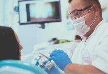 Male dentist with woman in chair