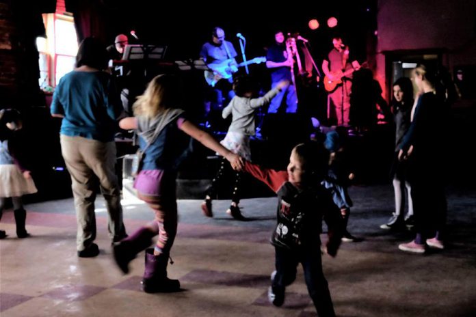 Peterborough reggae and ska band Dub Trinity are performing their annual tribute to Bob Marley this weekend at the Historic Red Dog in downtown Peterborough, with an evening show on Friday, March 6th followed by an all-ages matinee show at 2 p.m. on Saturday, March 7th when kids get in free. Pictured are kids dancing at the 2018 all-ages matinee show. (Photo: Selrahc Yrogerg via dubtrinity.com)