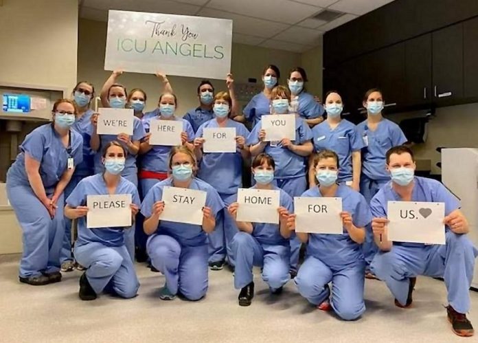 Front-line healthcare workers in the intensive care unit (ICU) at Peterborough Regional Health Centre have a message for all of us: "We're here for you. Please stay home for us." (Photo courtesy of The ICU Team at PRHC)