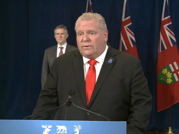Ontario Premier Doug Ford, with Minister of Finance Rod Phillips behind him, announcing the new Ontario-Canada Emergency Commercial Rent Assistance Program on April 24, 2020. (Screenshot / YouTube)