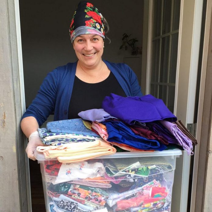 Peterborough's Madderhouse Textile Studios owner Leslie Menagh with some of the donated fabric to make headbands and caps for front-line healthcare workers at Peterborough Regional Health Centre. The New Canadians Centre’s sewing collective is also involved in the project, as is Repair Cafe Peterborough. (Photo courtesy of New Canadians Centre)