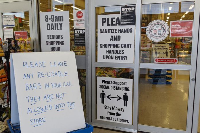 Signs, signs, everywhere signs. Morello's Independent Grocer in Peterborough has recently disallowed the use of re-usable bags by customers. (Photo: Bruce Head / kawarthaNOW.com)