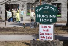 Healthcare workers at Pinecrest Nursing Home in Bobcaygeon wave as passing cars honk support on April 1, 2020. (Photo: Fred Thornhill / The Canadian Press)