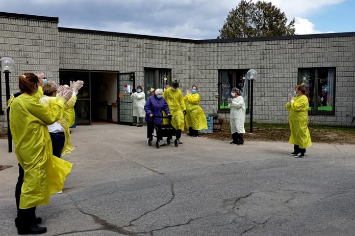 In a video taken by staff of Pinecrest Nursing Home in Bobcaygeon, health care workers at the home applaud as 91-year-old resident Lorraine Button goes for a walk on April 17, 2020 for the first time since the deadly outbreak of COVID-19 in the home, which has claimed the lives of 29 residents. (Screenshot)