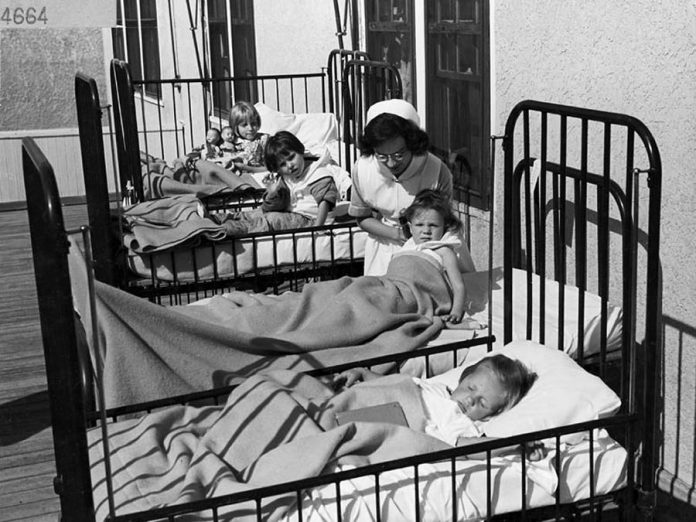 A nurse cares for children with polio at the University Hospital in Edmonton in this undated photo. (Photo: Library and Archives Canada)