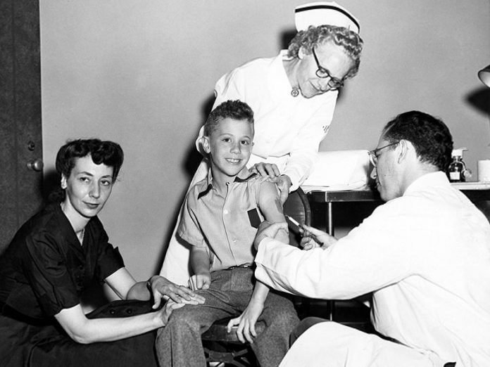 Peter Salk receiving the polio vaccine from his father, Jonas Salk, in 1953.  Salk injected himself, his wife, and their three sons with his experimental poliovirus vaccine. Today, Dr. Peter Salk lives in California where he is president of the Jonas Salk Legacy Foundation, as well as a visiting professor of infectious disease and microbiology at the University of Pittsburgh, where his father created the polio vaccine. (Photo: March of Dimes Foundation)