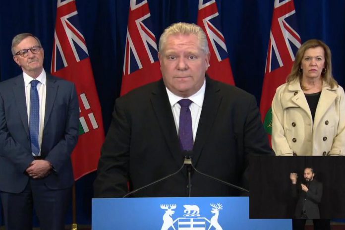 On April 3, 2020, a sombre Premier Doug Ford, accompanied by Ontario's Chief Medical Officer of Health Dr. David Williams and Deputy Premier and Minister of Health Christine Elliott, announnced new emergency meaures to prevent the spread of COVID-19 in Ontario, following the release of projections that Ontario will have 80,000 positive COVID-19 cases and 1,600 deaths by the end of April. (Photo: Office of the Premier / YouTube)