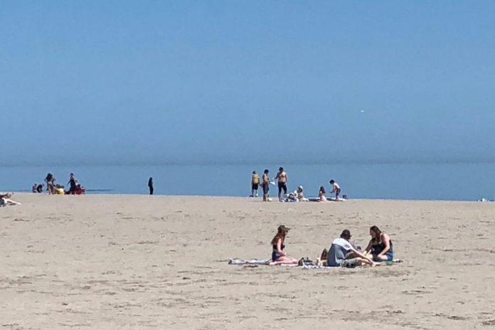 The Cobourg Police Service released this photo of Victoria Beach in Cobourg showing only small gatherings on the beach on May 23, 2020, the same day when an estimated 10,000 people gathered at Toronto's Trinity Bellwoods Park. (Photo: Cobourg Police Service)