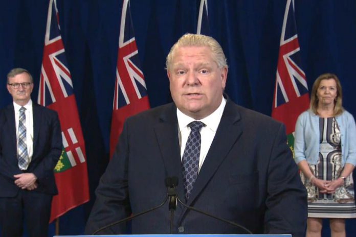 Ontario Premier Doug Ford announces the province's enhanced COVID-19 testing strategy at a media briefing at Queen's Park on May 29, 2020, along with Ontario's chief medical officer of health Dr. David Williams and health minister Christine Elliott. (Screenshot / CPAC)
