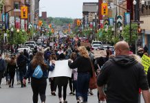 Hundreds of people, wearing masks and walking in small groups due to the COVID-19 pandemic, marched from Millennium Park to Confederation Square in downtown Peterborough on June 2, 2020 during a peaceful protest calling for an end to police violence against black and indigenous people of colour. (Photo courtesy of Sean Bruce)
