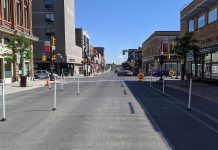 Downtown Peterborough looking south on George Street, now reduced to a single lane, towards Charlotte Street, which is now a single eastbound one-way lane between Aylmer and George. These are some of the changes being implemented by the City of Peterborough during stage two of the province's reopening during the COVID-19 pandemic to help create more space for pedestrians, restaurant patios, and pop-up commercial space. (Photo: Bruce Head / kawarthaNOW.com)
