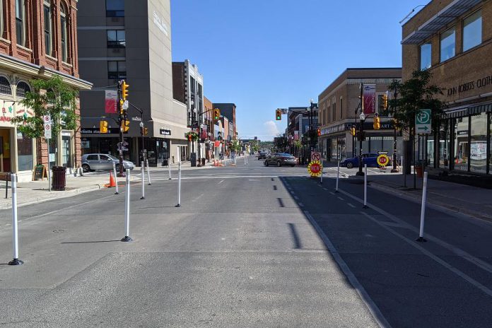 Downtown Peterborough looking south on George Street, now reduced to a single lane, towards Charlotte Street, which is now a single eastbound one-way lane between Alymer and George. These are some of the changes being implemented by the City of Peterborough during stage two of the province's reopening during the COVID-19 pandemic to help create more space for pedestrians, restaurant patios, and pop-up commercial space. (Photo: Bruce Head / kawarthaNOW.com)
