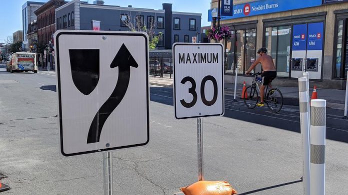 The cycling lanes on George Street and Water Street are unaffected by the changes. Road signage for reduced lanes, speed limits, and one-way streets is already in place. (Photo: Bruce Head / kawarthaNOW.com)