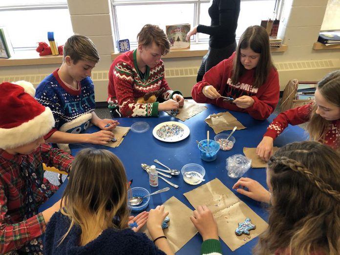 In December 2019, Monsignor O'Donaghue students celebrated their successful water retrofit application by rotating through festive stations. At this station, students decorate gingerbread folks while brainstorming what the expression “We are Water” means to them. From left to right: Lauren Graham, Nate O'Brian, Cooper Cook, Owen Cook, Sara McMahon, Isabel Brockley, and Kylie Lake. (Photo: GreenUP)