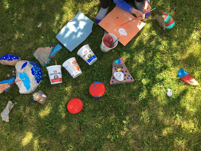 GreenUP communication and marketing specialist Leif Einarson involved his kids in a family activity to paint rocks for Peterborough GreenUP's Rainbow Rock Garden. The painted rocks are intended to spread a message of belonging and acceptance. (Photo: Leif Einarson / GreenUP)
