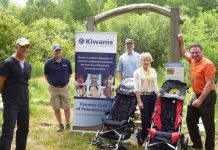 Peterborough Kiwanis Club and mobility and accessibility business Motion with the two trail chairs they have donated to Camp Kawartha to increase accessibility of trails at both of the camp's sites. Pictured from left to right: Camp Kawartha executive director Jacob Rodenburg, Kiwanis Club of Peterborough spokesperson Terry McLaren, Camp Kawartha Environment Centre manager Craig Brant, and Motion accessibility consultants Shelley McNamara and Rob Carleton. (Photo courtesy of Camp Kawartha)