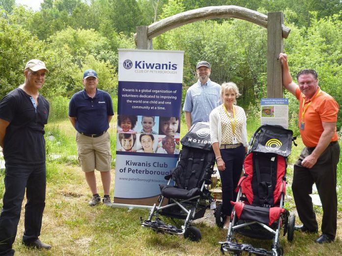 Peterborough Kiwanis Club and mobility and accessibility business Motion with the two trail chairs they have donated to Camp Kawartha to increase accessibility of trails at both of the camp's sites. Pictured from left to right: Camp Kawartha executive director Jacob Rodenburg, Kiwanis Club of Peterborough spokesperson Terry McLaren, Camp Kawartha Environment Centre manager Craig Brant, and Motion accessibility consultants Shelley McNamara and Rob Carleton. (Photo courtesy of Camp Kawartha)