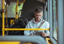 A man travelling on a transit bus