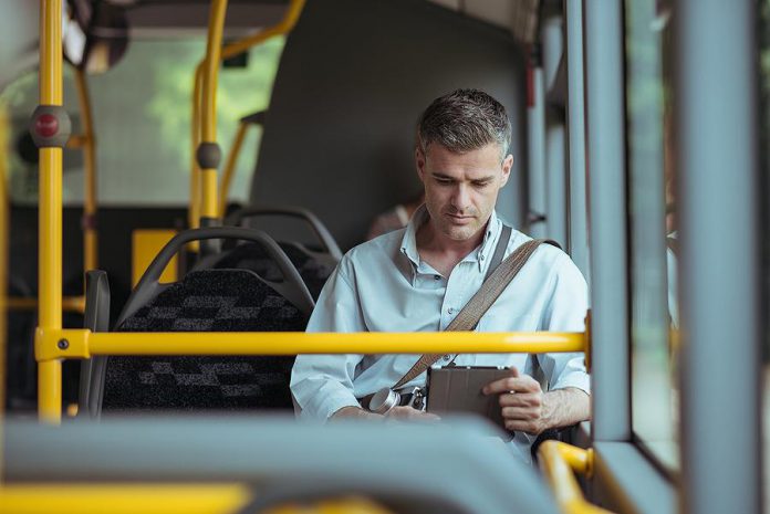 A man travelling on a transit bus
