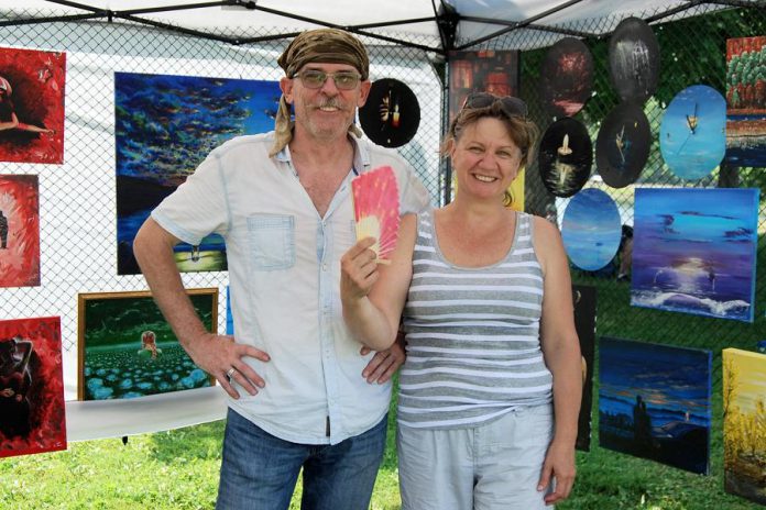 Artist Aleks Goloborodko and his wife Iryna left troubled Ukraine for Peterborough several years ago, joining their son who was studying at Trent University. Here the couple displays some of Aleks's paintings at the annual Multicultural Canada Day Festival, organized by New Canadians Centre to celebrate the diversity that is part of Canada's identity. This year's in-person festival has been cancelled due to COVID-19, so the New Canadians Centre is virtually sharing the stories of new Canadians like Aleks. (Photo: New Canadians Centre)
