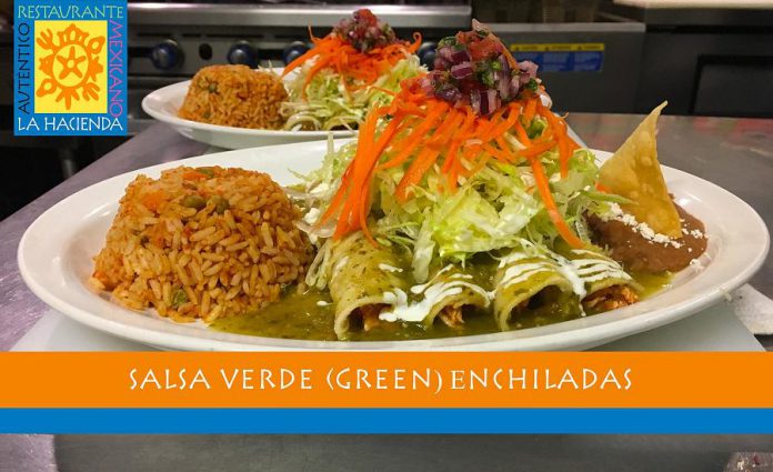 La Hacienda's enchiladas are lightly seasoned corn tortillas wrapped around chicken tinga or homemade refried beans, with salsa verde and garnished with shredded iceberg lettuce, crumbled cheese, and drizzled with sour cream. Mexican rice and homemade refried beans are served on the side. (Photo courtesy of La Hacienda)