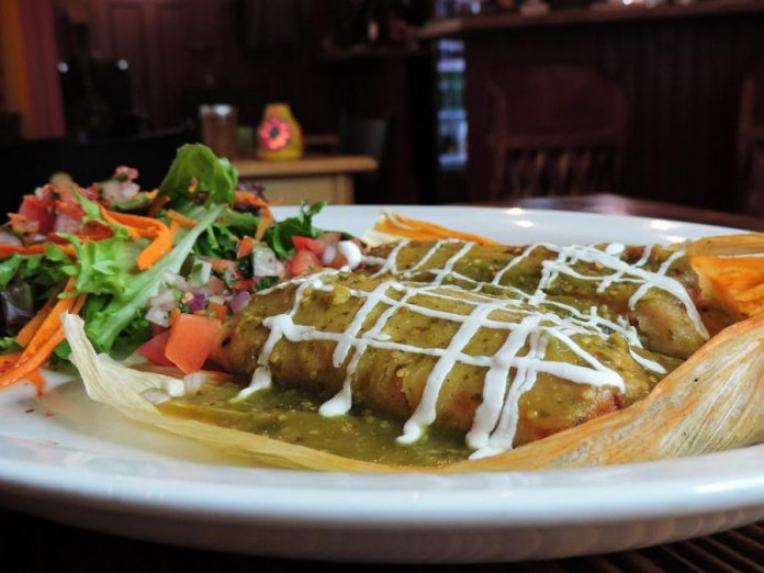 La Hacienda's traditional "tamal" features corn dough filled with pork loin in adobo sauce or vegetables, wrapped in a corn husk and steam-cooked to perfection. (Photo courtesy of La Hacienda)