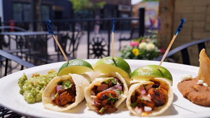 La Hacienda's tacos feature soft gluten-free corn tortillas filled with tender marinated pork loin and pineapple or mushrooms, served with the famous La Hacienda guacamole and refried beans. (Photo courtesy of La Hacienda)