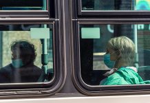 A trransit rider wearing a face mask during the COVID-19 pandemic