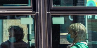 A trransit rider wearing a face mask during the COVID-19 pandemic