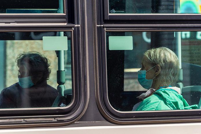 A trransit rider wearing a face mask during the COVID-19 pandemic