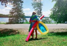 A young girl during summer heading to a beach for a swim. (Stock photo)