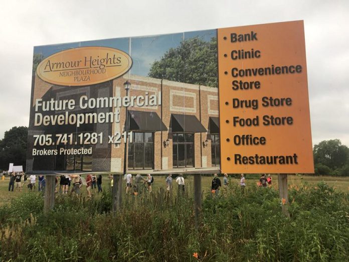 This billboard, located in a vacant field at Armour Road and Ashburnham, has long advertised the original intent of Parkview Homes to develop the site for commercial use. Now Parkview wants to build a seven-storey apartment building on the site. On July 7, Peterborough city council, sitting as general committee, voted 7-4 in favour of changing the land use designation from commercial to high-density residential.  (Photo: Paul Rellinger / kawarthaNOW.com)