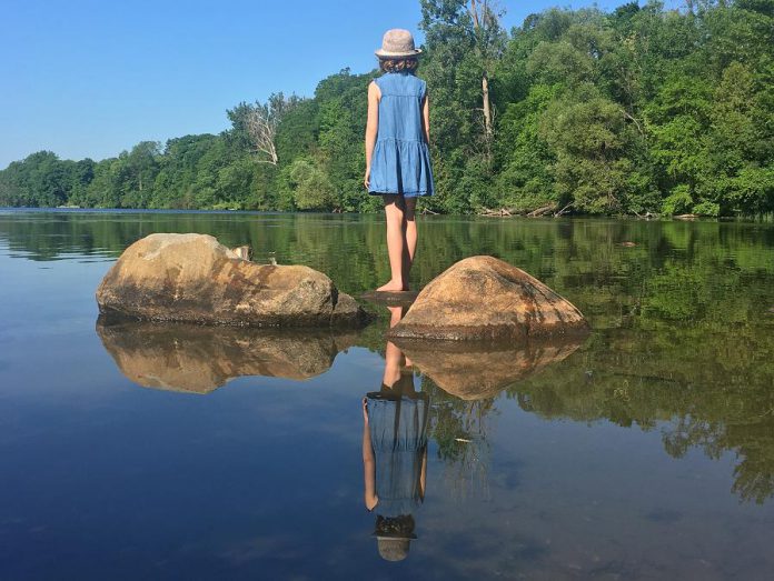 A young girl looks out over the picturesque Otonabee River just upstream from Peterborough's water treatment plant. After drawing water from the Otonabee River, the City of Peterborough processes and tests it to ensure the water is safe for drinking straight from your tap.  (Photo: Leif Einarson / GreenUP)