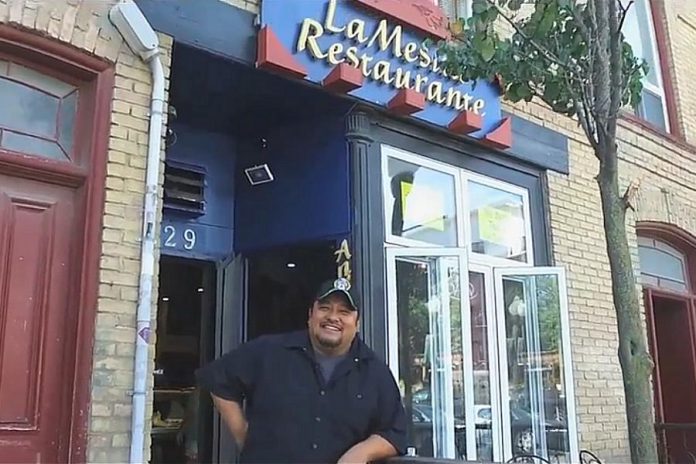 Martin Carbajal pictured in a video in front of his restaurant at 229 Hunter Street West in downtown Peterborough in 2018, when he was nominated for the Immigrant Entrepreneur of the Year Award at the Peterborough Chamber of Commerce's Business Excellence Awards. He went on to win the award. (Screenshot: Peterborough Chamber of Commerce)