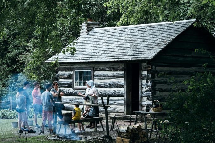 A guided tour in 2019 at Lang Pioneer Village Museum in Keene. The museum is now open for summer 2020 and is offering pre-booked guided tours for groups of up to nine people from the same family or social circle. This year, visitors will be required to maintain physical distancing and wear face masks when inside museum buildings. (Photo: Chance Faulkner)