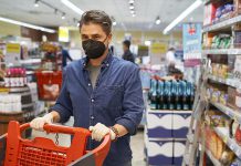 A middle-aged man wearing a face mask in a store. (Stock photo)