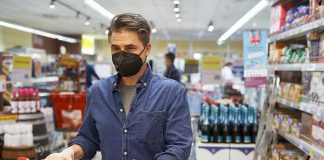 A middle-aged man wearing a face mask in a store. (Stock photo)
