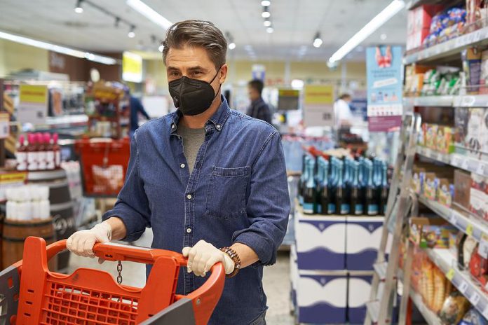 A middle-aged man wearing a face mask in a store. (Stock photo)