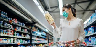 A woman wearing a face mask in a grocery store. (Stock photo)