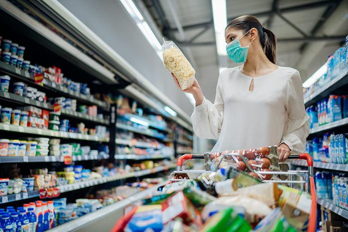 A woman wearing a face mask in a grocery store. (Stock photo)