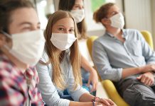 Young people wearing masks during COVID-19 pandemic. (Stock photo)