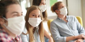 Young people wearing masks during COVID-19 pandemic. (Stock photo)
