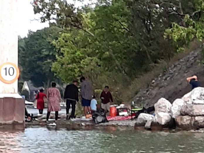 People are fishing from the edge of James A. Gifford Causeway both during the day and during the night, often leaving their garbage behind for local businesses and residents to clean up. (Photo: Wylie Harold)