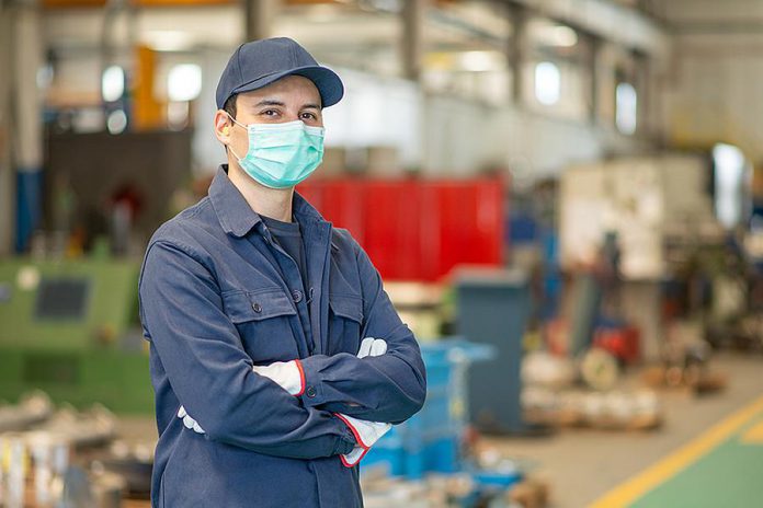 A factory worker wearing a mask. (Stock photo)