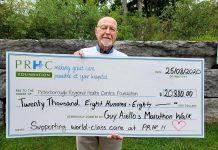 99-year-old Guy Aiello with a $20,880 cheque for Peterborough Regional Health Centre (PRHC) Foundation. Aiello, who celebrates his 100th birthday this fall, walked the equivalent of a marathon in July 2020 to raise funds for equipment and technology at the hospital. (Photo: PRHC Foundation / Facebook)