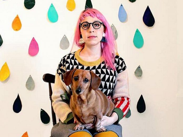 Peterborough artist Kathryn Durst (pictured with her dog Chili) has been selected to create a public art mural in downtown Peterborough commissioned by the First Friday Ptbo Art Crawl. Trained in animation, Durst is now an illustrator of children's books, including Sir Paul McCartney's best-selling children's book "Hey Grandude!", which was published in 2019. (Photo via First Friday Ptbo / Facebook)