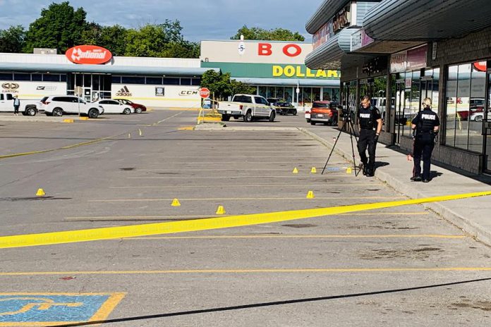 Police cordoned off the parking lot at Market Plaza, located at the corner of George and Rink streets in Peterborough, as they documented the scene of a double stabbing the morning of August 18, 2020. Two Peterborough men have been arrested and charged following an investigation. (Photo courtesy of Brian Parypa)